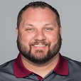 Posed head and shoulders photograph of Anderson with a beard wearing a grey Buffalo Bills polo shirt