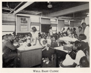 A room filled with young children sitting at desks.