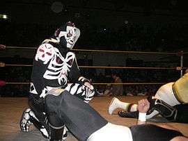 A masked wrestler wearing a full body suit that makes him look like a skeleton/