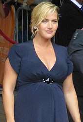 A pregnant Kate Winslet poses for the camera.
