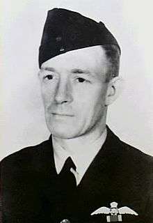 Portrait of man in dark military uniform with forage cap