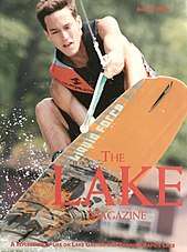 A muscular and determined wakeboarder grabs board as he soars through the air on cover of magazine. THE LAKE MAGAZINE. A REFLECTION OF LIFE ON LAKE GASTON AND ROANOKE RAPIDS LAKE. AUGUST 2008.