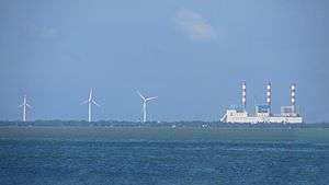 Wind turbines of the Mampuri and Madurankuliya wind farms next to the Lakvijaya Power Station, as seen from the Puttalam Lagoon.