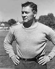 A black and white photo of Curly Lambeau from the waist up