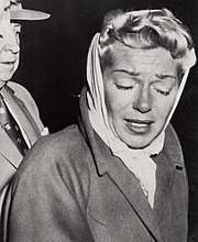 Woman wearing headscarf, crying
