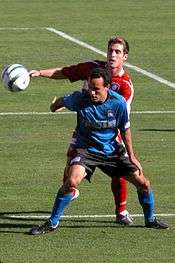 Landon Donovan fighting a ball against Carlos Bocanegra during MLS Cup 2003.