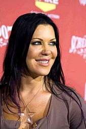 Chyna smiling at event wearing clear star necklace