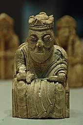 Photograph of an ivory gaming piece depicting a seated king