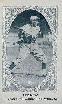 A black-and-white baseball card image of a man in an old-style white baseball uniform; the caption reads "LEE KING; Outfielder, Philadelphia Nationals"