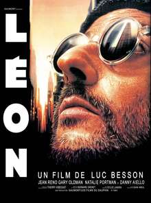 Picture of Jean Reno as Leon: He is bearded and wearing sunglasses looking upwards.