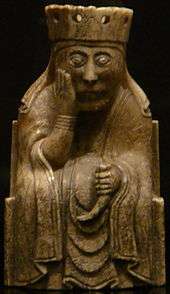 Photograph of an ivory gaming piece depicting a seated queen