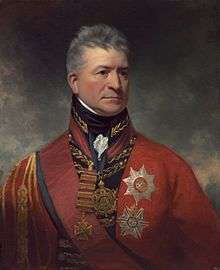 Painting shows a stern-looking man wearing an elaborate red military uniform with two large awards pinned to his breast.