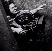 A black and white photograph of film director Lino Brocka behind the camera