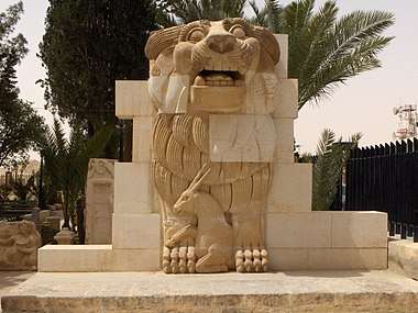 Stone lion, with a gazelle between its front legs