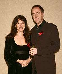 Colour upper-body photograph of Angus Deayton and his then-partner Lise Mayer in 2003.