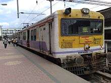 White-and-yellow electric train at a station