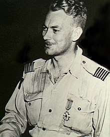 Informal half-portrait of blond man in light-coloured military uniform