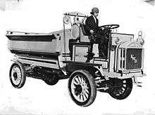 Promotional photo of Luella Bates driving a FWD model B truck.