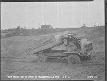 Luella Bates unloading sand from a FWD Model B truck.