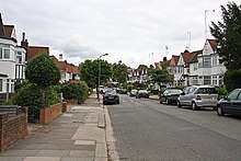 A wide suburban street with semi-detached housing