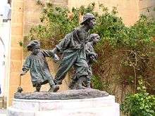 bronze sculpture of three street children running playfully