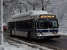 A Q65 bus as seen during a snowy day. The sign at the front of the bus signifies that it will short-turn at Goethals Avenue, rather than running the full route.