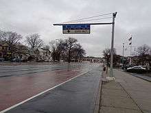 Offset, red-painted bus lane on Woodhaven Boulevard, north of Metropolitan Avenue, in Queens