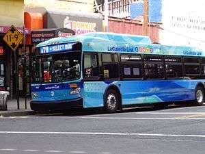A Q70 SBS bus in LaGuardia Link livery, stopping in Woodside, Queens
