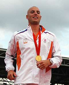Maarten van der Weijden with a gold medal hung around his neck on a red ribbon