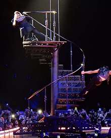 A spiral staircase with Madonna at the top hanging out towards the audience.