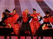 Madonna and her dancers in Japanese dresses, holding fans in their hand