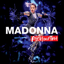 Madonna in a flapper dress dancing onstage with the album name written across her image.