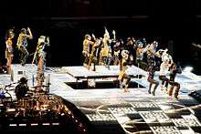 Madonna dancing in costume, with many other dancers