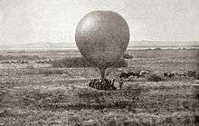 Contemporary image of a tethered, round observation balloon being prepared for use
