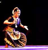 Photograph of a dancer wearing black Sari.