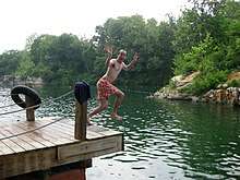 A man jumps into Beaver Dam.