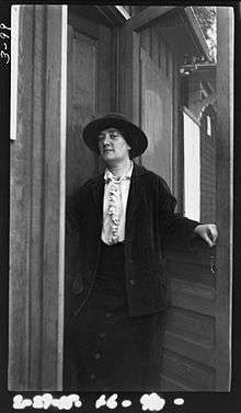 Black and white photograph of Margaret Turnbull, standing in a door way.