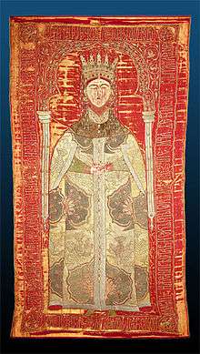 Tapestry of woman with a crown on her head wearing a decorated heavy coat