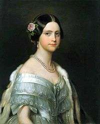 Half-length painted portrait of a young woman wearing a white satin ball gown trimmed with bows and lace, and also wearing an ermine stole thrown over one shoulder, a double strand of large pearls around her neck, pearl drop earrings, and a pink camellia arranged in the hair over her right ear.
