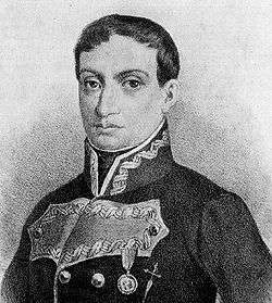 Black and white print of a dark-haired man with large round eyes. He wears a dark military coat.