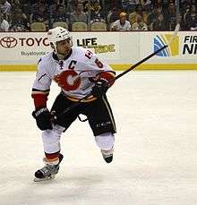Giordano skates toward the camera as he observes the play off to his left.