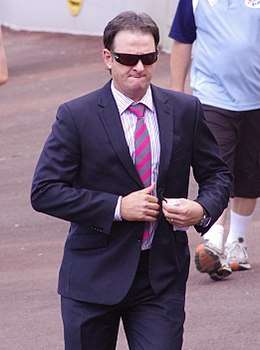 Mark Waugh in a suit and sunglasses.