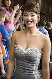 Mary Elizabeth Winstead, a Caucasian female, is wearing a gray dress and looking a few degrees sideways from the camera.