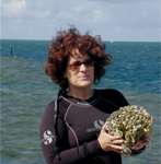 Photo of Mary Hagedorn working in the field with coral species
