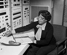 Mary Jackson sitting, adjusting a control on an instrument
