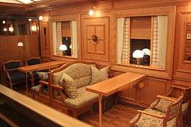 Wood-paneled dining car, with comfortable seating