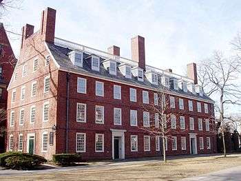 A four-story brick building with many windows.