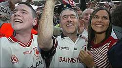 Photo of Michaela Harte at right, with father Mickey Harte centre, and brother Matthew at left, celebrating Tyrone's 2003 football final win.
