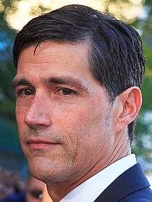 Matthew Fox behind the microphone at a convention.