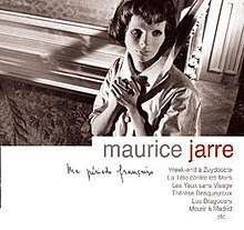 A woman grasping her hands together looks off to her left while standing against a wall. Text below the image reads "Maurice Jarre", followed by other French text.